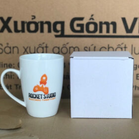 Ly sứ in logo Rocket dáng vát có quai màu trắng XG-LS168